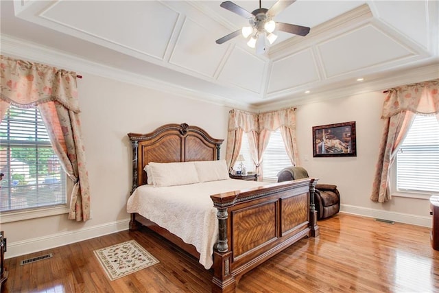 bedroom with ornamental molding, coffered ceiling, wood-type flooring, and ceiling fan