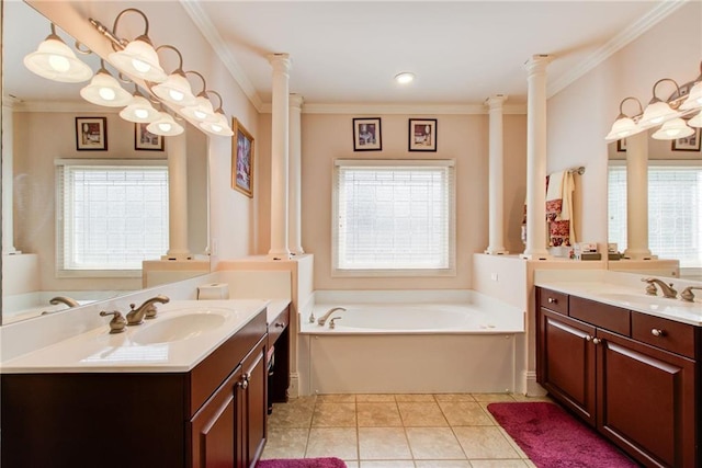 bathroom featuring tile patterned flooring, vanity, a bathing tub, and ornate columns