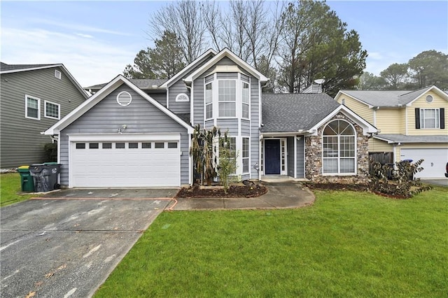 view of property featuring a front yard and a garage