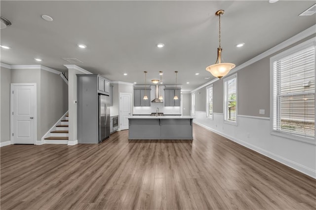 1179 Bennett Creek Overlook, Suwanee, GA 30024 - kitchen with stainless steel refrigerator, gray cabinets, ornamental molding, open floor plan, and baseboards