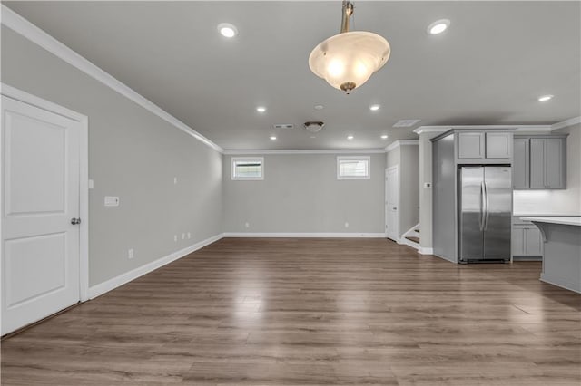 1179 Bennett Creek Overlook, Suwanee, GA 30024 - unfurnished living room with crown molding, recessed lighting, baseboards, wood finished floors, and stairs