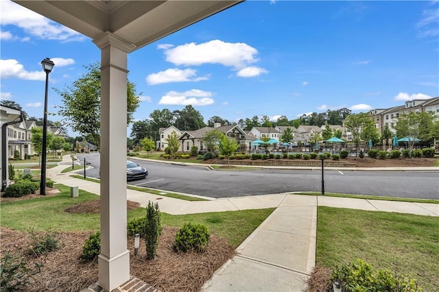 1179 Bennett Creek Overlook, Suwanee, GA 30024 - view of street with sidewalks, a residential view, street lights, and curbs