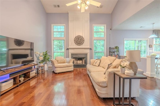 2022 Maple Ridge Dr NW, Acworth, GA 30101 - living area with a fireplace, hardwood / wood-style floors, ceiling fan, and a towering ceiling