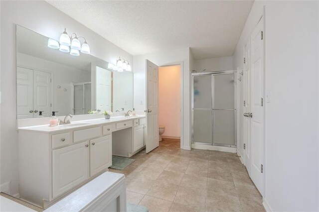 2022 Maple Ridge Dr NW, Acworth, GA 30101 - bathroom with a stall shower, toilet, a textured ceiling, and double vanity