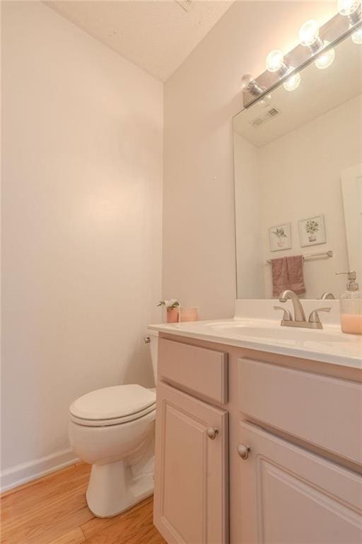 2022 Maple Ridge Dr NW, Acworth, GA 30101 - bathroom featuring wood finished floors, toilet, vanity, and baseboards
