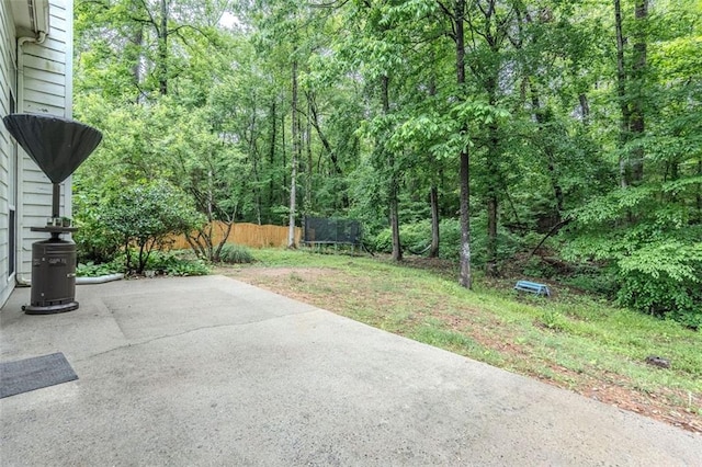 2022 Maple Ridge Dr NW, Acworth, GA 30101 - view of patio featuring fence, a trampoline, and a view of trees