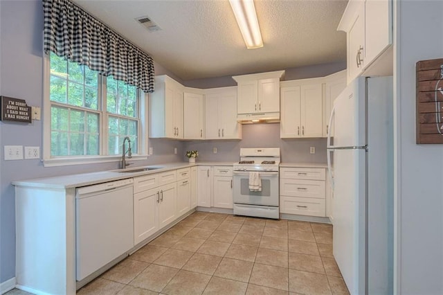 2022 Maple Ridge Dr NW, Acworth, GA 30101 - kitchen featuring white appliances, a sink, under cabinet range hood, light countertops, and a textured ceiling