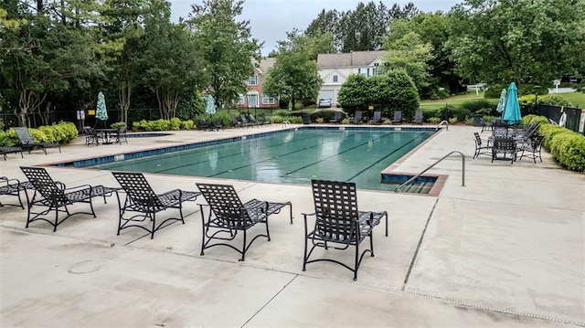 2022 Maple Ridge Dr NW, Acworth, GA 30101 - community pool featuring fence, a patio area, and view of wooded area