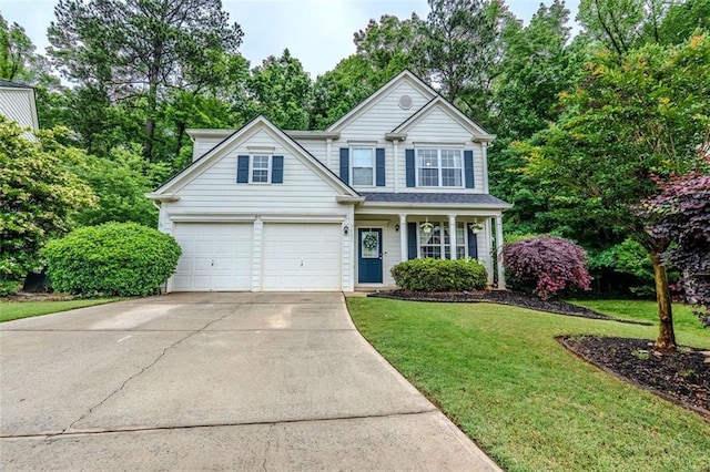2022 Maple Ridge Dr NW, Acworth, GA 30101 - traditional-style home with concrete driveway, a front lawn, a porch, and view of wooded area