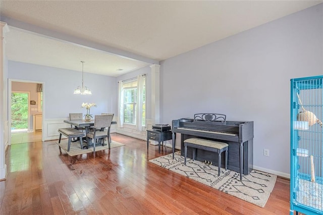 2022 Maple Ridge Dr NW, Acworth, GA 30101 - dining room featuring wood finished floors, a chandelier, and decorative columns