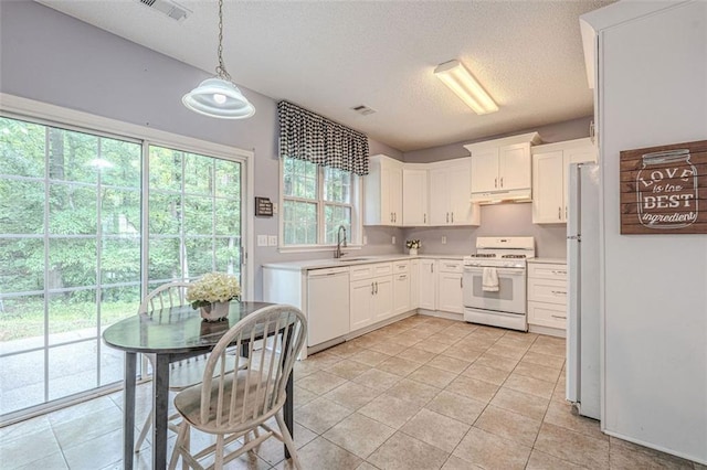 2022 Maple Ridge Dr NW, Acworth, GA 30101 - kitchen featuring white appliances, under cabinet range hood, a textured ceiling, light countertops, and a sink