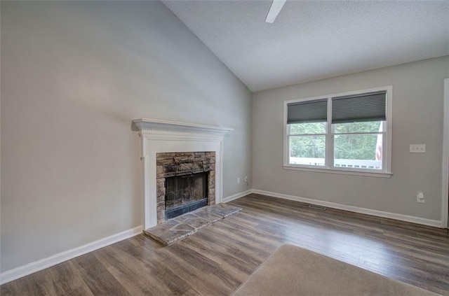 80 Broadlands Dr, White, GA 30184 - unfurnished living room featuring wood finished floors, a stone fireplace, lofted ceiling, and a textured ceiling