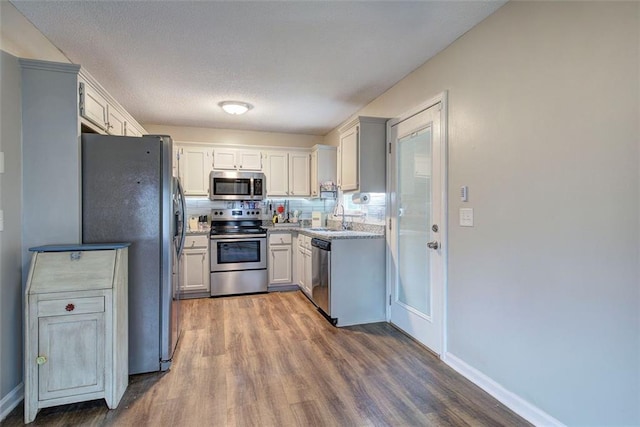 80 Broadlands Dr, White, GA 30184 - kitchen with appliances with stainless steel finishes, wood finished floors, light countertops, and white cabinets