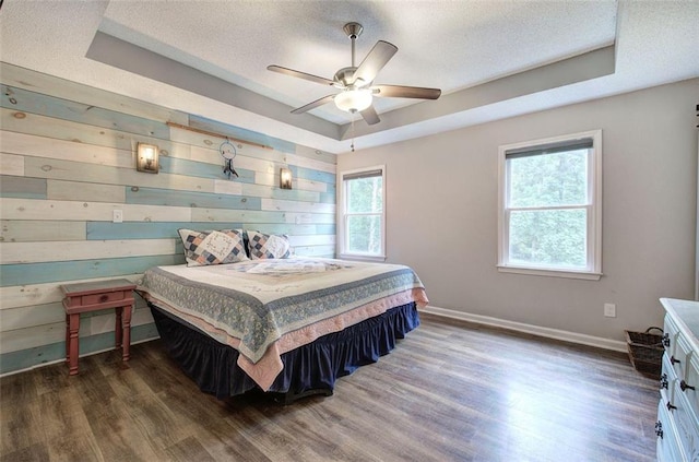 80 Broadlands Dr, White, GA 30184 - bedroom with a tray ceiling, wood finished floors, a textured ceiling, wooden walls, and ceiling fan