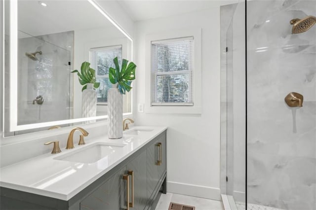 bathroom with tile patterned floors, vanity, and walk in shower