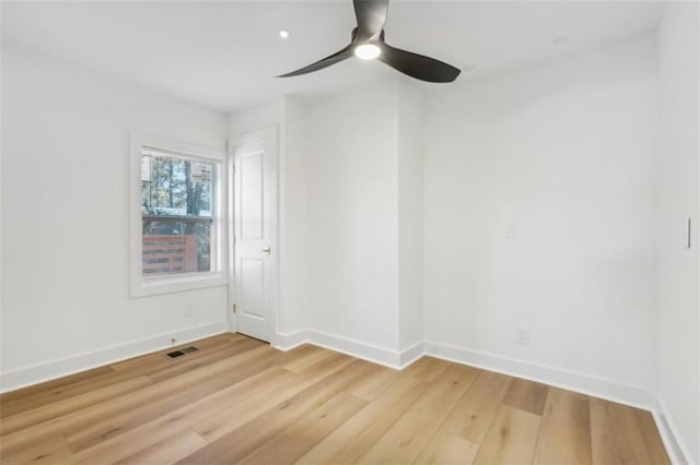 empty room with light hardwood / wood-style flooring and ceiling fan