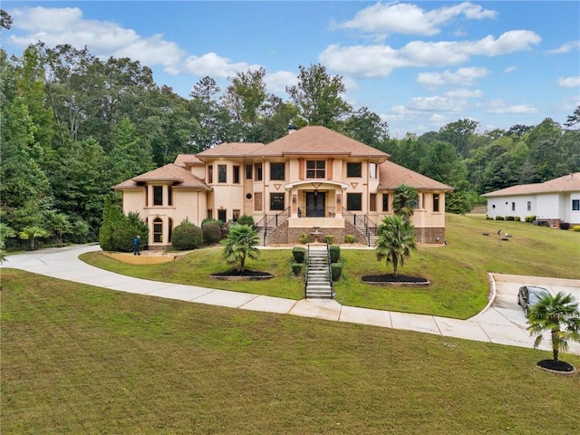 mediterranean / spanish house featuring a front yard