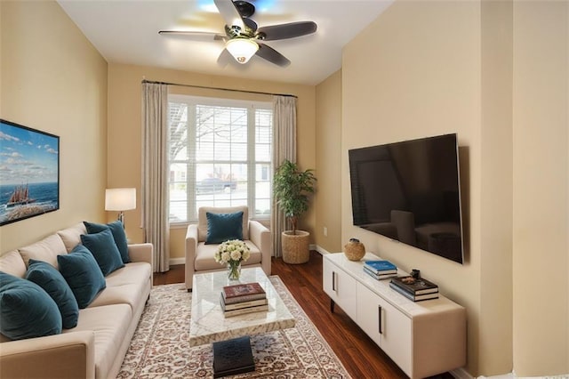 living room with dark hardwood / wood-style flooring and ceiling fan