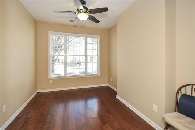 spare room featuring ceiling fan and dark hardwood / wood-style flooring