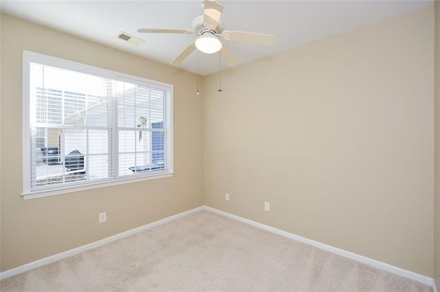 empty room with light colored carpet and ceiling fan