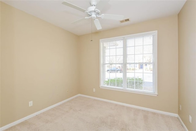 empty room featuring light carpet and ceiling fan