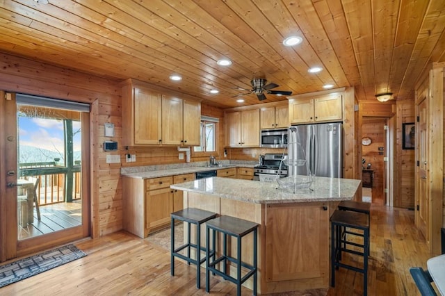 kitchen with wooden ceiling, wood walls, light wood finished floors, and stainless steel appliances