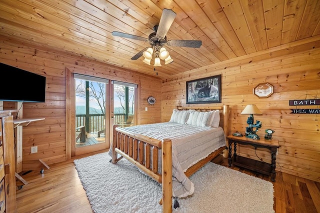 bedroom featuring wood ceiling, wood finished floors, a ceiling fan, and access to outside