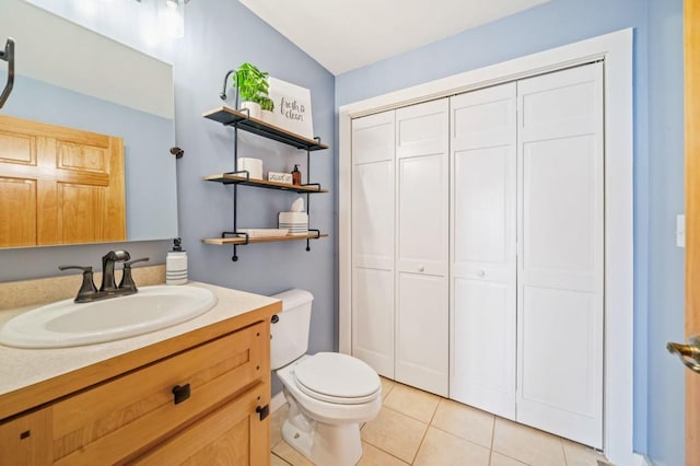 bathroom featuring toilet, vanity, and tile patterned flooring