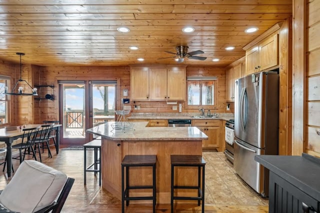 kitchen featuring wooden ceiling, french doors, freestanding refrigerator, a kitchen breakfast bar, and gas stove