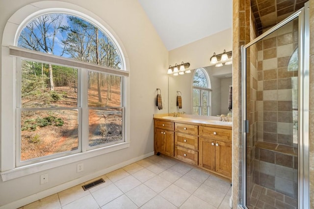 bathroom featuring visible vents, a stall shower, a sink, tile patterned flooring, and double vanity