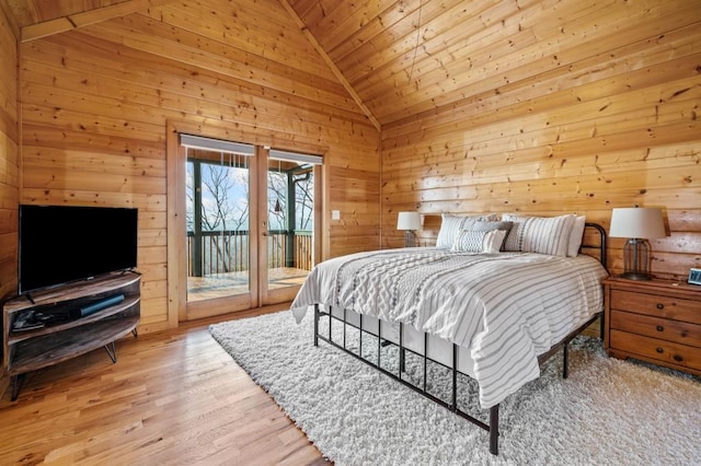 bedroom featuring high vaulted ceiling, access to outside, wood finished floors, wooden walls, and wooden ceiling