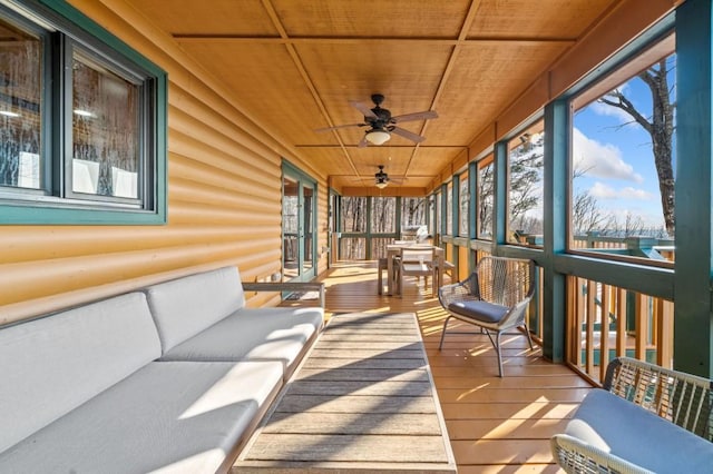 sunroom / solarium featuring a healthy amount of sunlight and wood ceiling