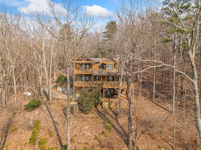 back of property featuring a deck and stairway