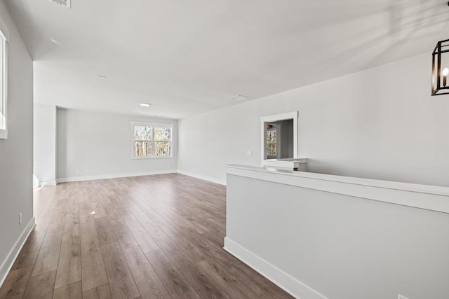 unfurnished room featuring baseboards and wood finished floors