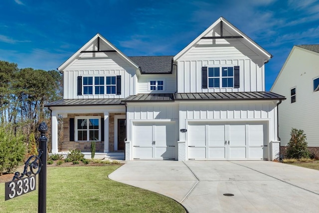 modern farmhouse with an attached garage, driveway, board and batten siding, a standing seam roof, and a front yard