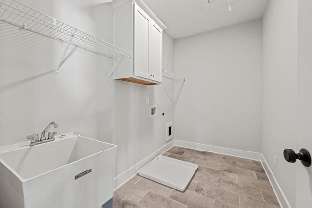 clothes washing area with cabinet space, baseboards, a sink, hookup for a washing machine, and electric dryer hookup