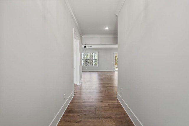 corridor featuring dark wood-style floors, recessed lighting, crown molding, and baseboards