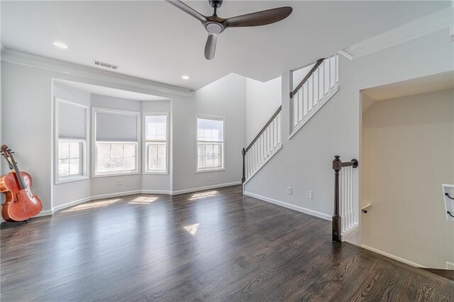 2164 Mill Garden Run, Buford, GA 30519 - unfurnished living room featuring visible vents, baseboards, ceiling fan, crown molding, and dark wood-type flooring