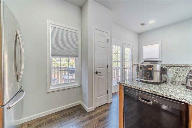2164 Mill Garden Run, Buford, GA 30519 - kitchen with visible vents, dishwasher, dark wood-style flooring, freestanding refrigerator, and a healthy amount of sunlight