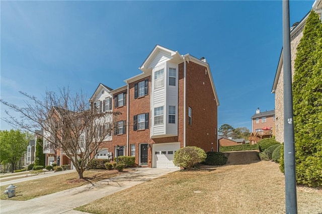 2164 Mill Garden Run, Buford, GA 30519 - view of front facade featuring brick siding, a front yard, a garage, and concrete driveway