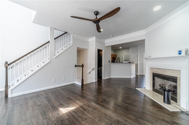 2164 Mill Garden Run, Buford, GA 30519 - unfurnished living room with baseboards, a ceiling fan, crown molding, a high end fireplace, and wood finished floors