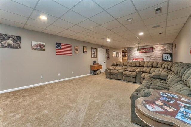 carpeted living area with visible vents, a paneled ceiling, and baseboards