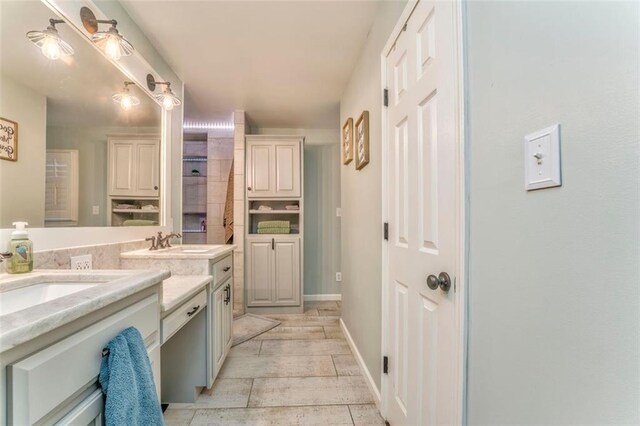 bathroom featuring baseboards and vanity