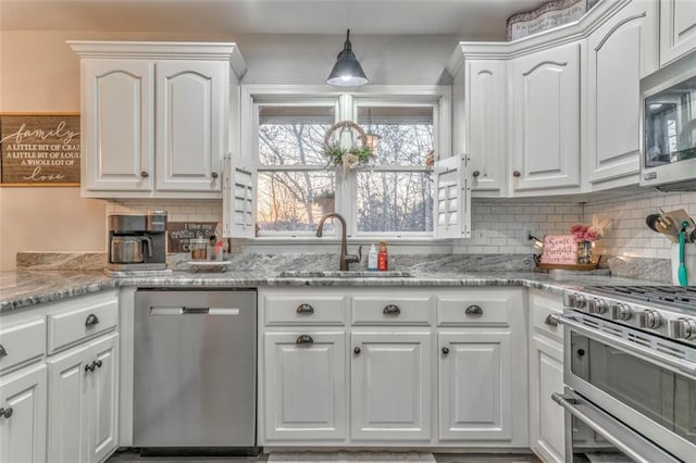 kitchen with white cabinetry, tasteful backsplash, appliances with stainless steel finishes, and a sink