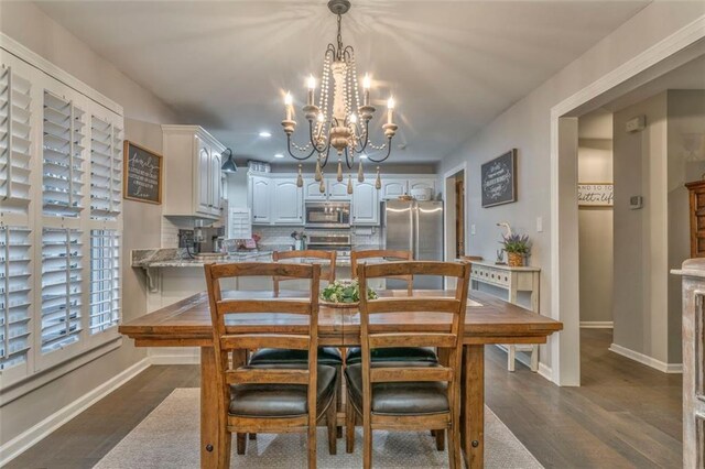 dining space with dark wood-type flooring and baseboards