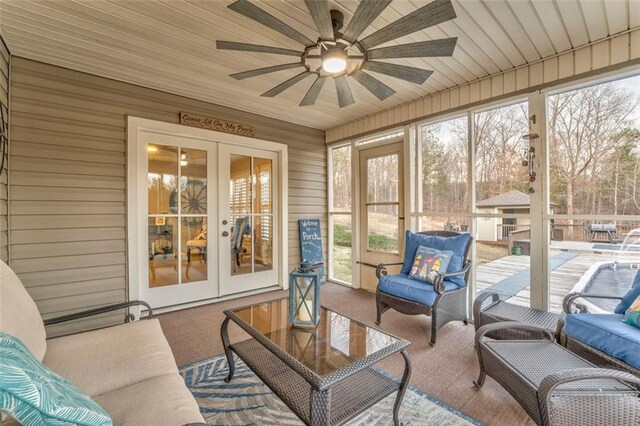 sunroom featuring french doors and ceiling fan