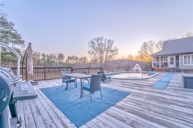 view of swimming pool with a wooden deck and a fenced in pool