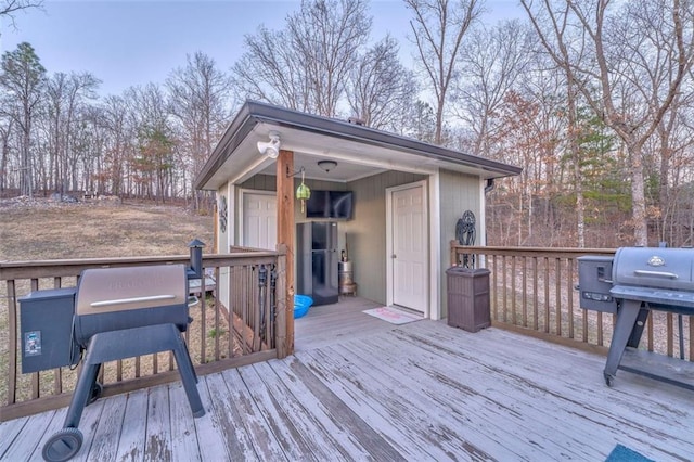 wooden terrace with a grill