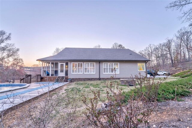 back of property featuring a covered pool and a sunroom