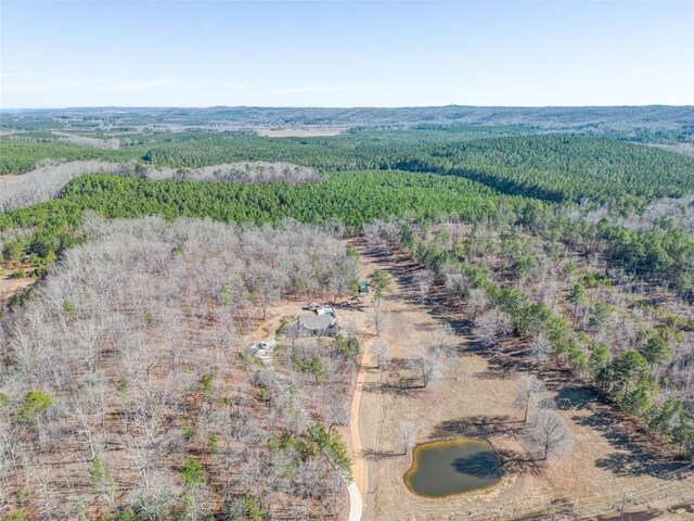 birds eye view of property with a view of trees